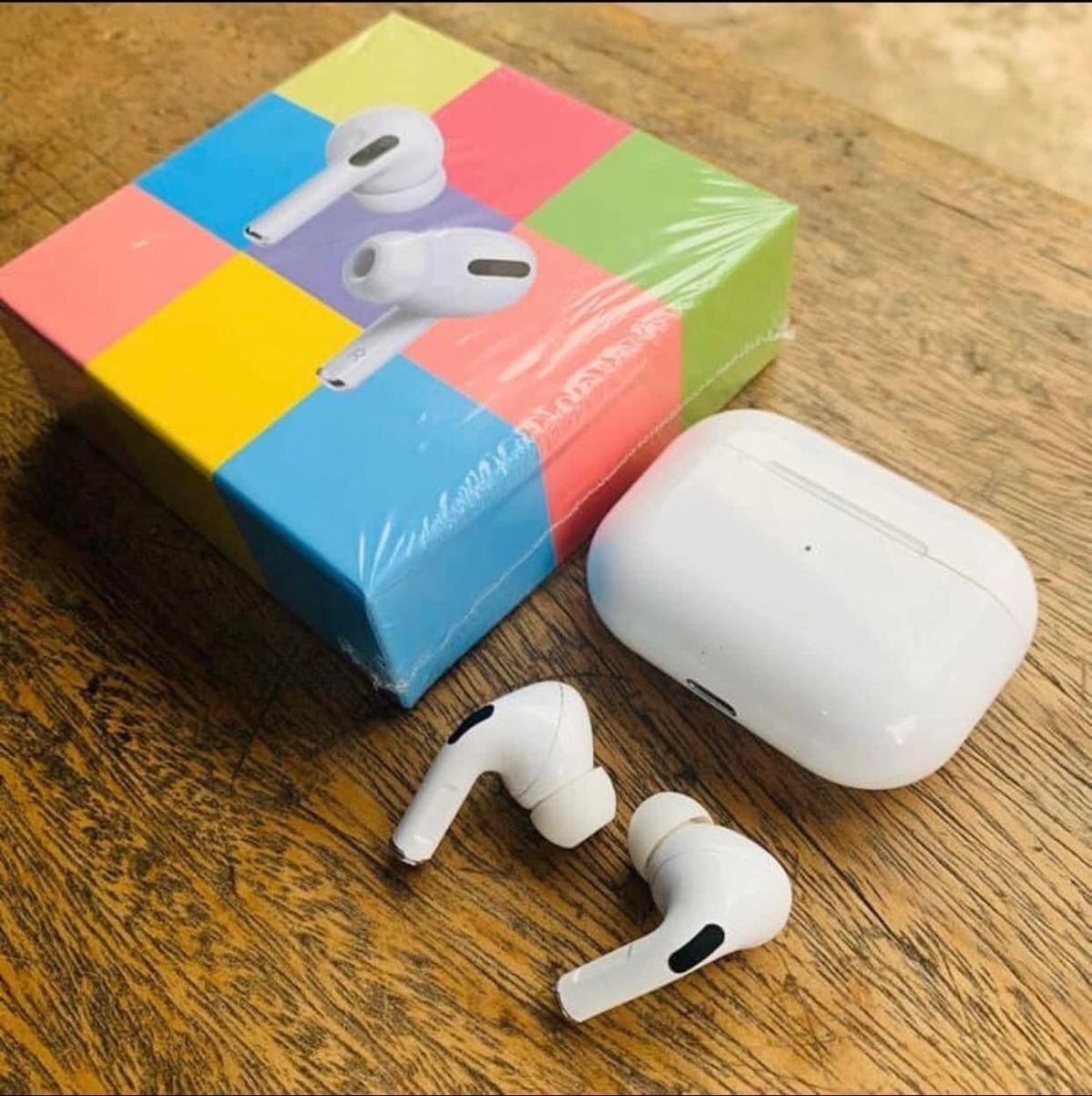 White wireless earbuds and charging case with colorful retail box